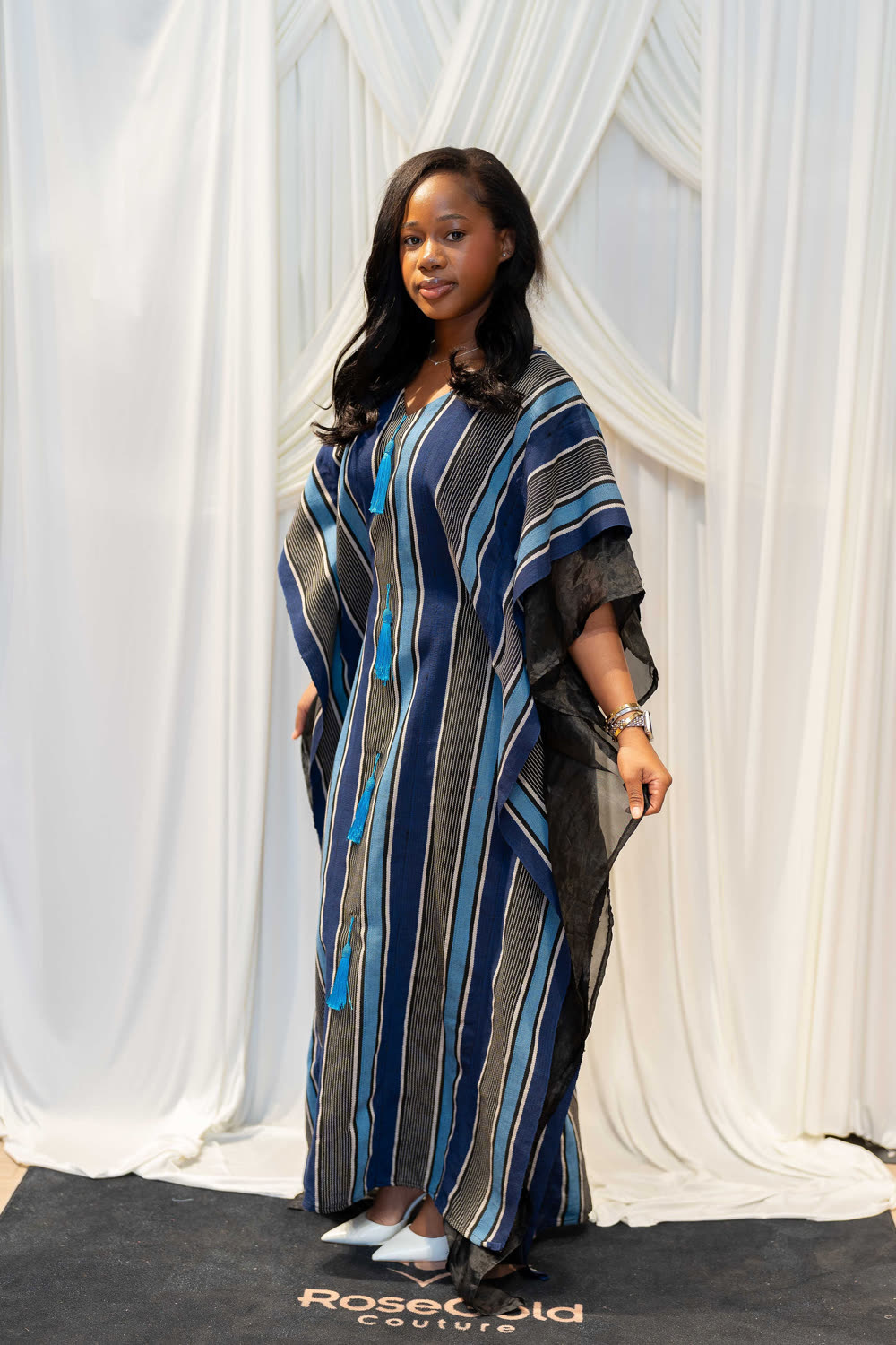 Model wearing a handwoven indigo Aso Oke kaftan by RoseGold Couture